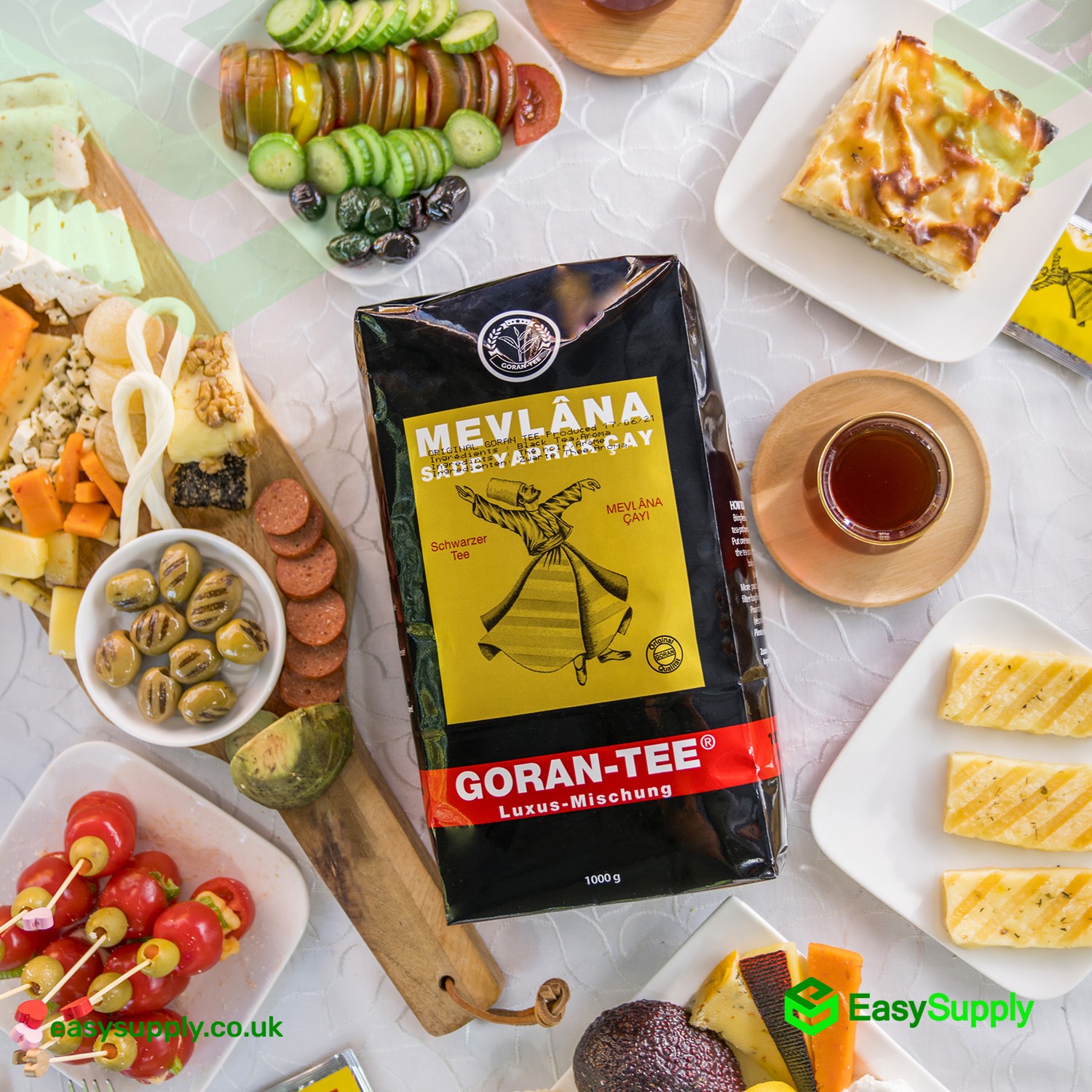 Mevlana Goran Tee 1000 g pack on a Turkish breakfast table with a glass of brewed tea