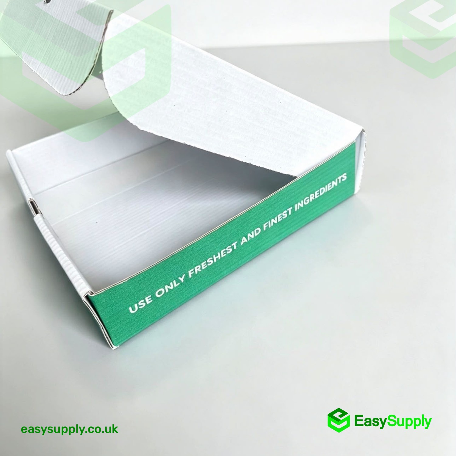 Open white pizza box showing the green Use Only Freshest Ingredients side band
